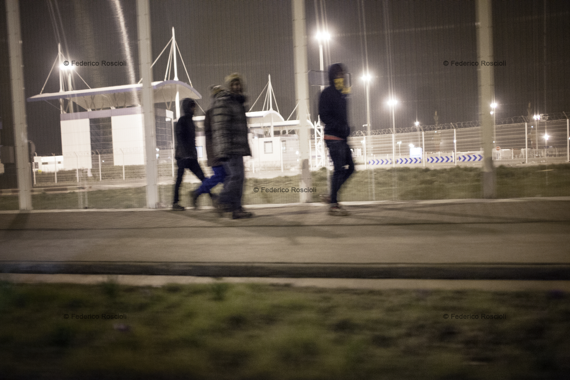 Calais, France. February 28, 2016. Migrants returning to the camp. During evenings and nights migrants walk from the camp to the train station or the truck parking in order to 'try it', meaning try to reach the UK.