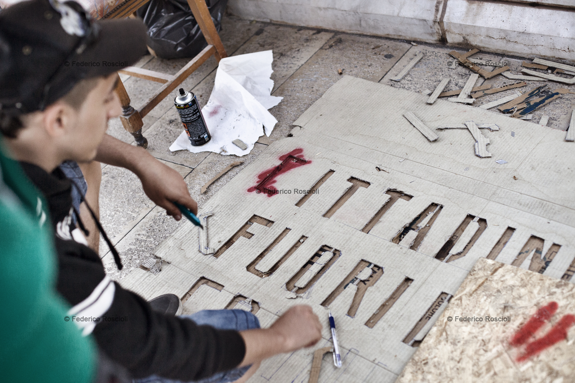 Taranto, Italy, September 23, 2013. The making of a stencil during the  fourteenth day of protests under the municipality of Taranto. This sit-in lasted 26 days and was organized by associations and citizens of Taranto united under the name of 'Cittadini #fuoridalcomune' (Citizens outside of the municipality building): they asked more attention and participation by the local institution on environmental issues.