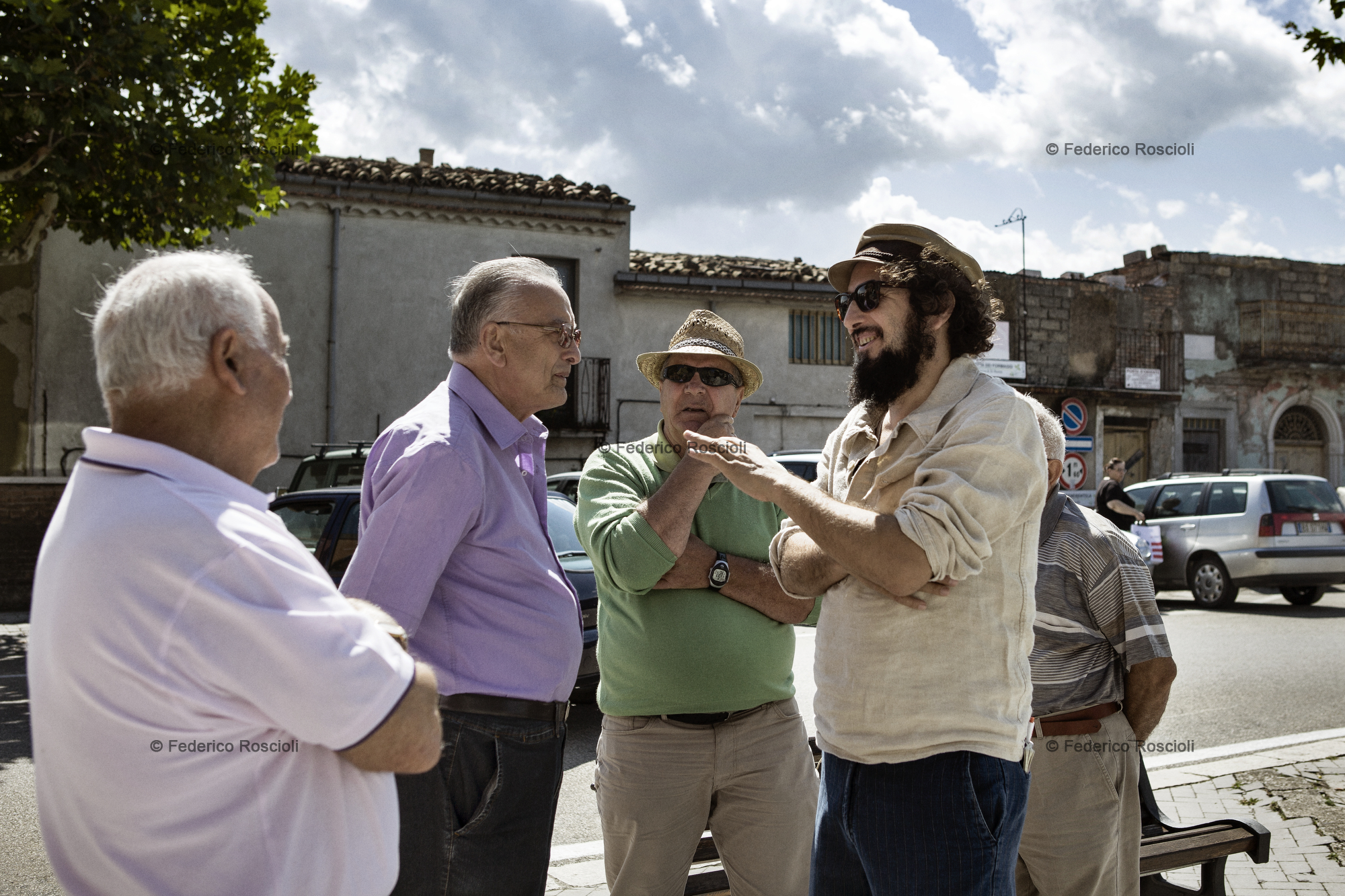 Calitri, Avellino, Italy. August 28, 2013. Raffaele, Armando, Vinicio, and some other friends talking in the square of the Municipal of Calitri.