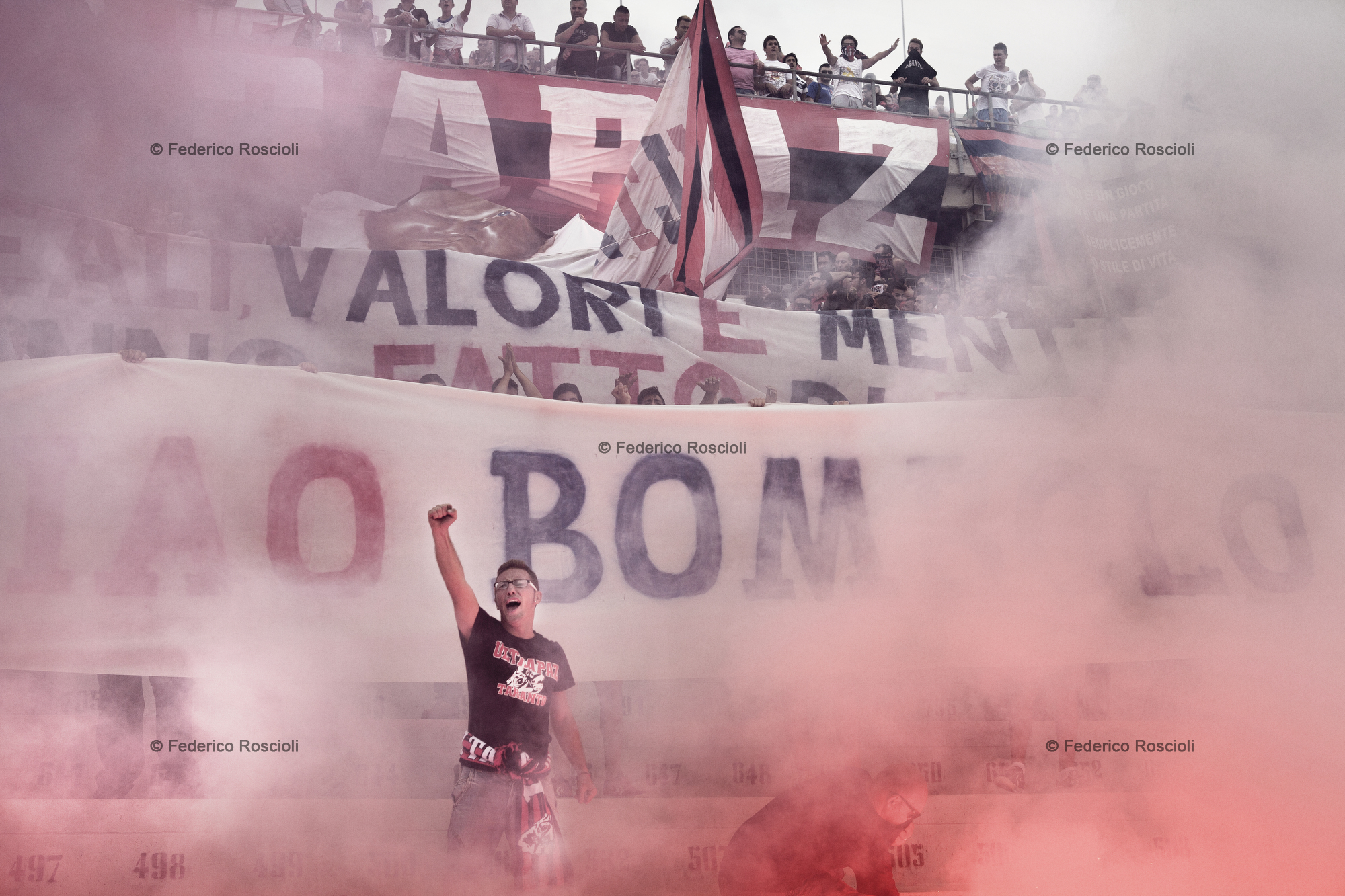 Taranto, Italy, September 29, 2013. Supporters remembering one of their buddy passed away with smoke and banners in Erasmo Iacovone Stadium in Taranto. Taranto Calcio plays actually in 4th division, due to the failure of the society, anyway it has an average attendance of around 2500 supporters. In the past taranto played 32 seasons in second division. The 'curva', in 1977 and 2001, was awarded as the best of Italy.